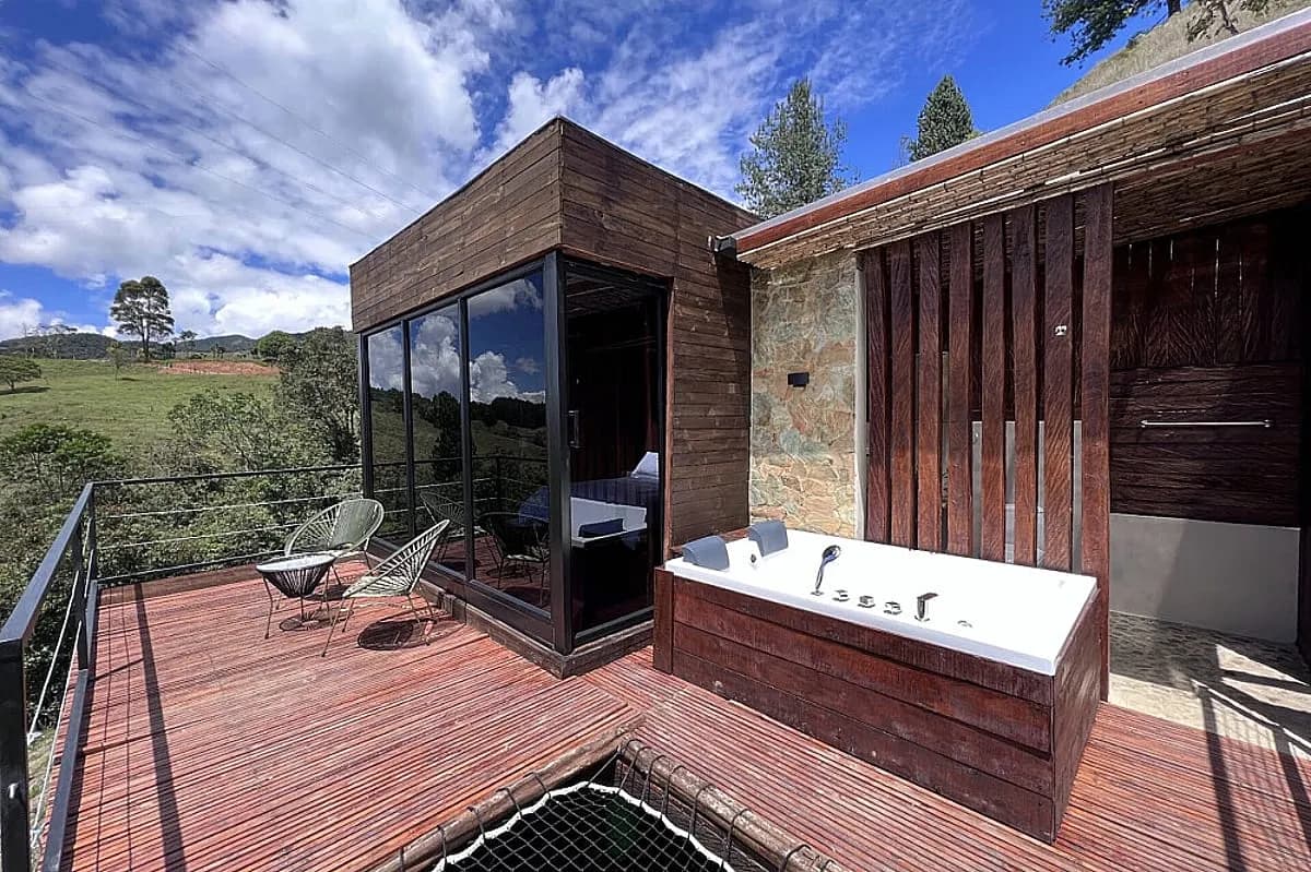 Private cabin terrace with outdoor soaking tub at Yaogará