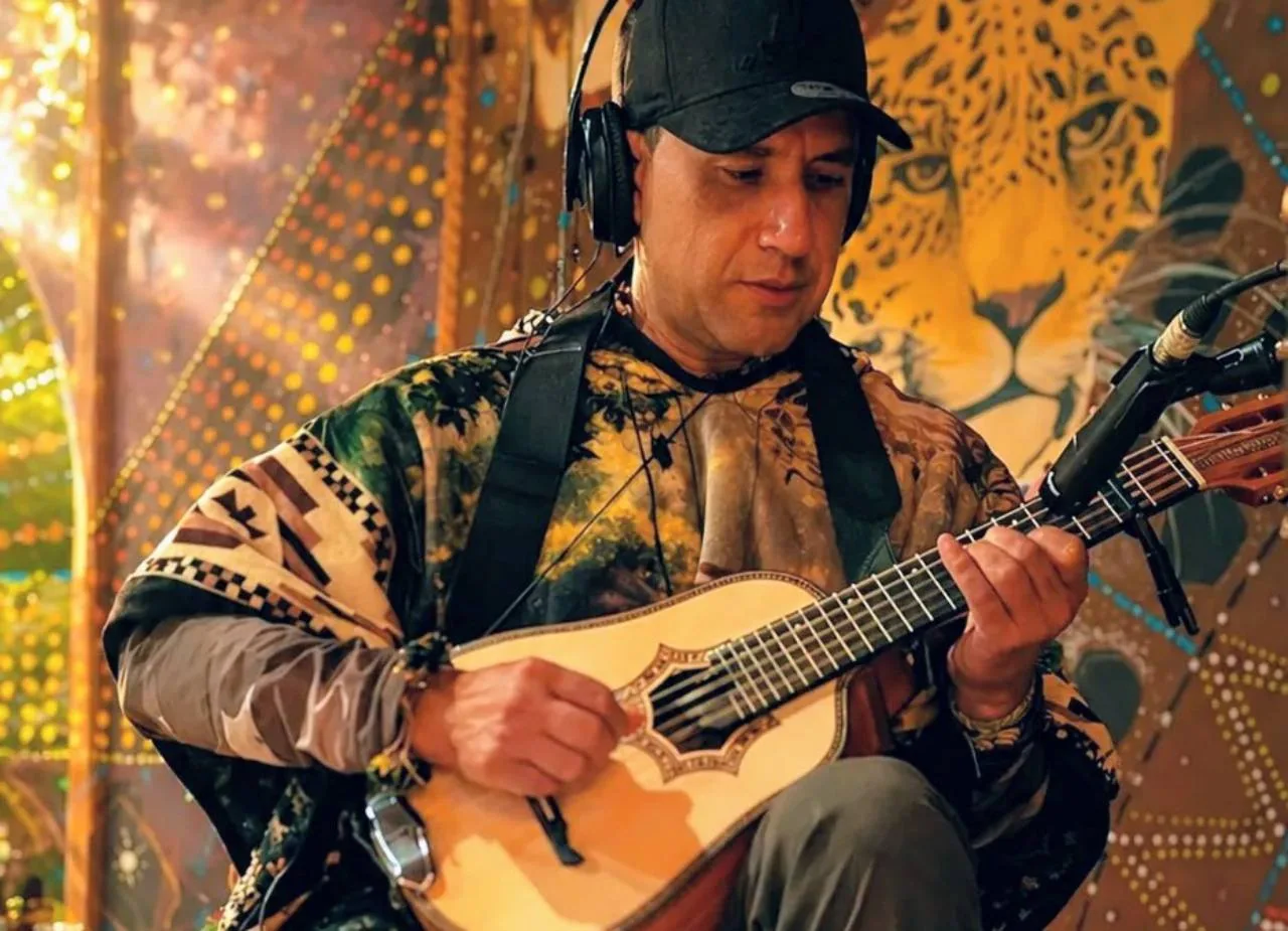 Diego Marmolejo playing a bandolin in the Medicine House at Camino al Sol